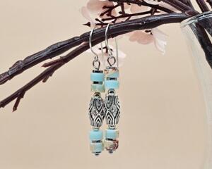 Handmade earrings with stacked sea sediment jasper beads and an ornate antiqued silver center bead.